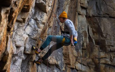 Climber on the canyon walls at The Canyon at Pond Creek glamping resort in Tennessee